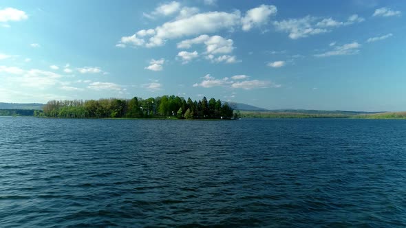 Low flight over Oravska Priehrada lake revealing Slanica Island, Namestovo, Slovakia