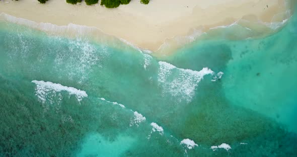 Luxury flying abstract view of a summer white paradise sand beach and blue ocean background in 4K