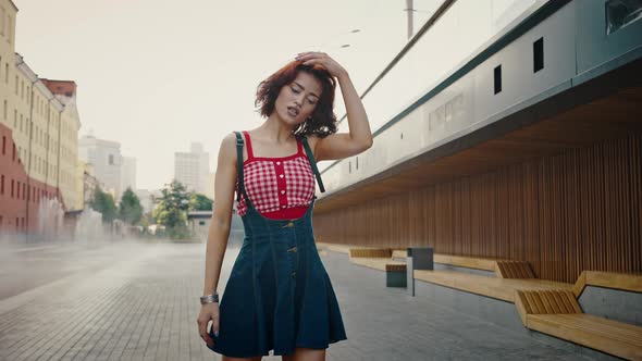 Young Beautiful Pin Up Woman in Squads Rinking in Urban Park Near Fountains Dancing Alone Outdoors