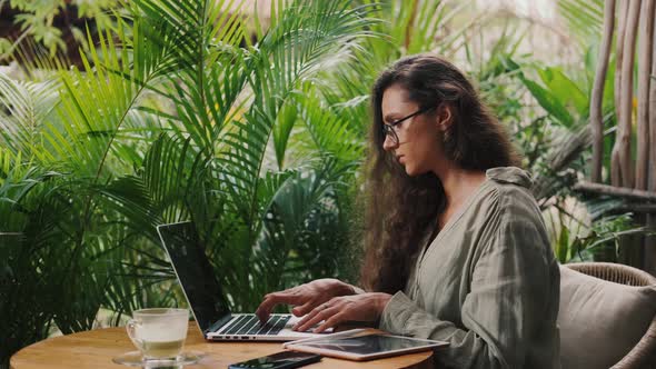 Beauty Woman Using Laptop in Cafe