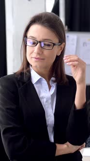 Vertical Video Portrait of Pretty Elegant Business Woman in Formal Clothes with Glasses