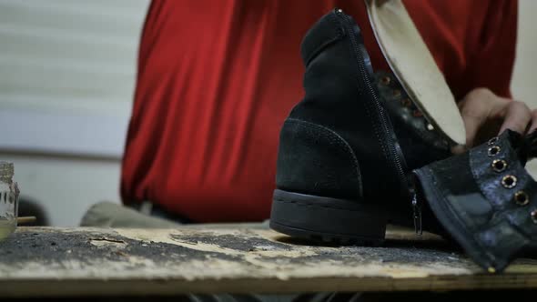 the Process of Gluing an Insole Into a Shoe By a Shoemaker