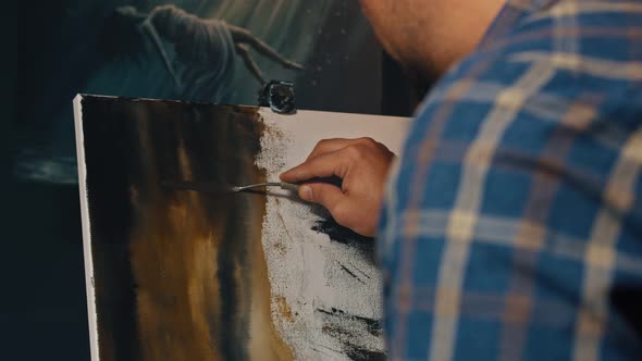 Close Up of Male Hand Using Art Spatula While Drawing on Easel at Studio