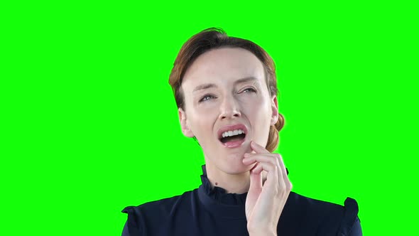 Worried Caucasian woman on green background