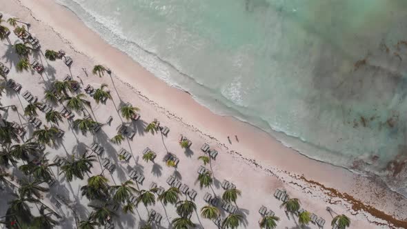 Well done aerial of turquoise water waves lapping onto the tropical shores of a resort in the Gulf o