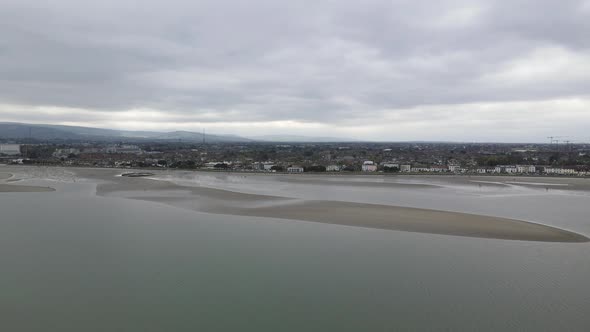 Lifeless Sandymount strand shores approaching Dublin city distantly