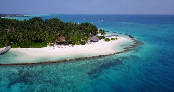 Wide birds eye travel shot of a paradise sunny white sand beach and aqua turquoise water background 