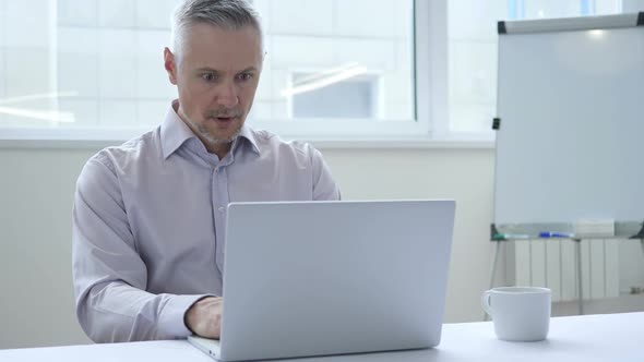 Shocked Businessman Working on Laptop Astonished