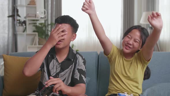 Children With Joystick Game Play Video Game On Tv, Girl Celebrating Victory And Boy Disappointed