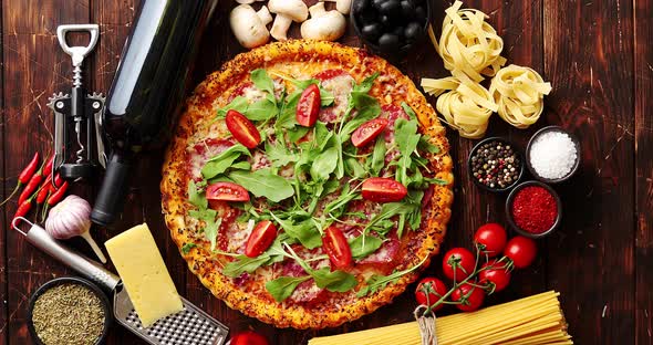Italian Food Background with Pizza, Raw Pasta and Vegetables on Wooden Table