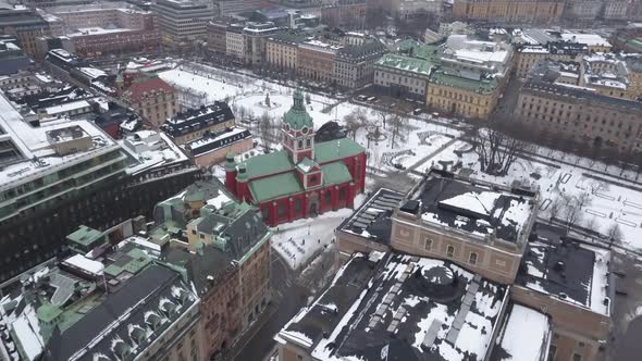 Aerial footage zooming in on vibrant Red and green church in central Stockholm,Sweden.