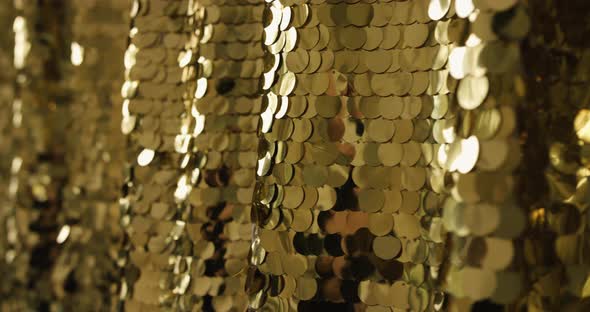 Festive Gold Fabric Texture with Shiny Particles Close Up. Beautiful Shiny Golden Background of