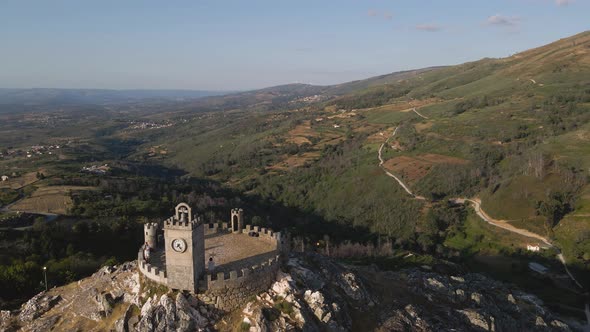 Fly over the towers at the Folgosinho Castle in Portugal.