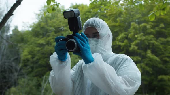 Criminalists Taking Pictures at Crime Scene in Forest Using Professional Photo Camera Taking