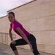 Sportswoman is Doing Physical Exercise Outdoors in City in Morning - VideoHive Item for Sale