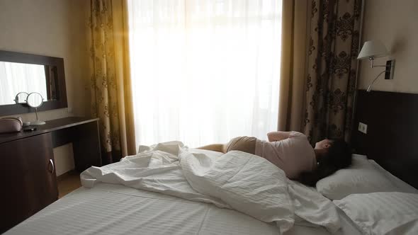 Woman Wakes Up and Stretches