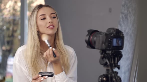 European Blond Beautiful Makeup Artist Is Applying Powder