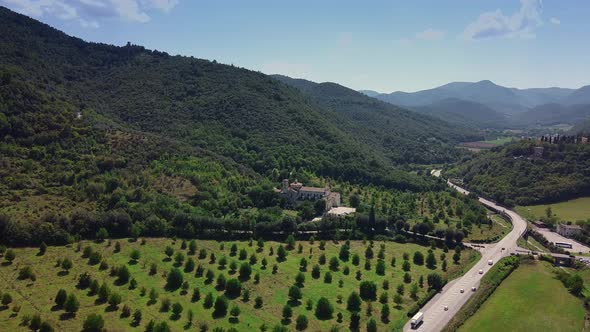 Awesome Aerial View of Mountainous Landscape with City Suburbs and Green Forests