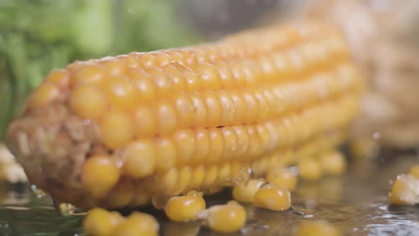 Water Falling Into Yellow Sweet Corn. - close up, slow motion