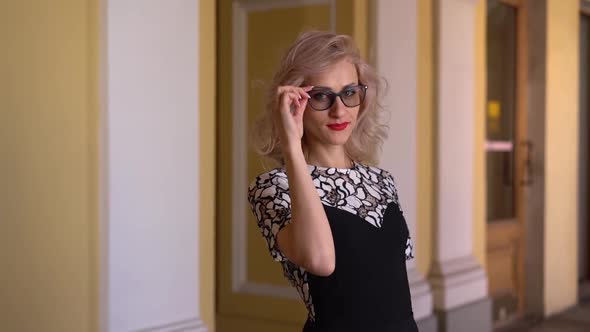 Half Length Portrait Beautiful Blonde Takes Off Her Glasses Dressed in Dress