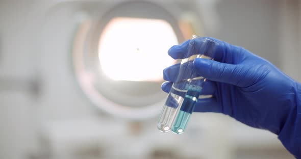 Portrait of Female Scientist with a Pipette Analyzes a Liquid To Extract the DNA in Lab