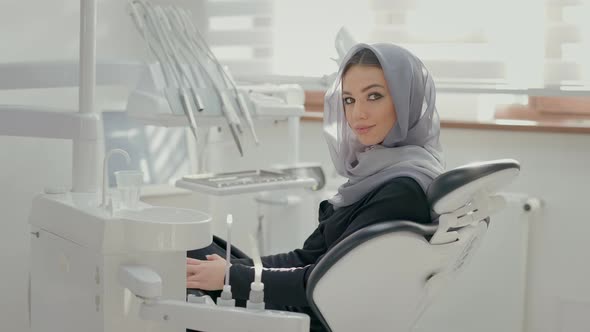 Beautiful Girl With Scarf On His Head Sitting To Dentists Chair