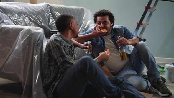 AfricanAmerican Guys Eat Talk and Relax Sitting on Floor