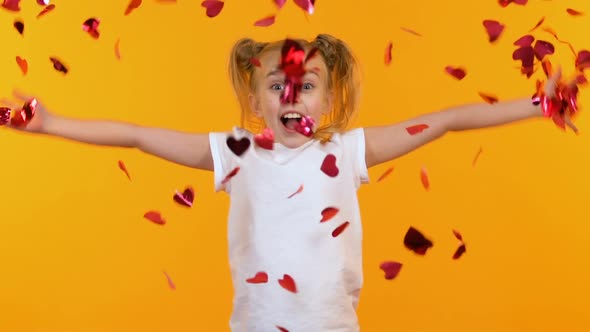 Excited Girl Throwing Heart-Shaped Confetti Into Air, Children Party, Slow-Mo