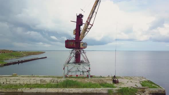 An Old Abandoned Rusty Crane in the Seaport