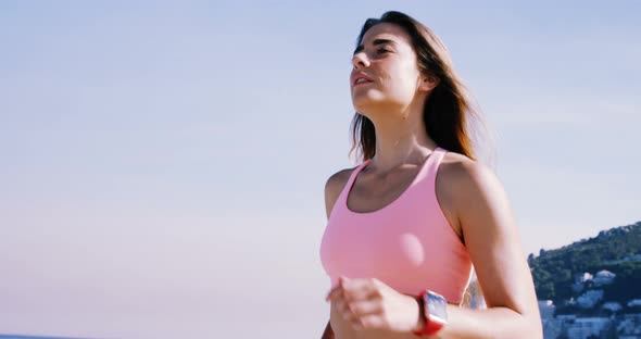 Fit woman jogging on the beach