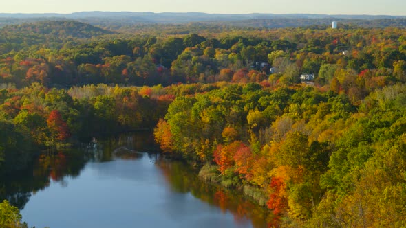 Aerial of beautiful lake amidst the autumn forest