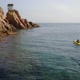 Following a young man kayaking near the cliffs - VideoHive Item for Sale