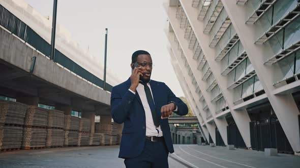 Confident African American Businessman Discussing Project Details with Partners Via Cellphone