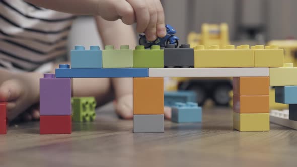 Unrecognizable Child Kid Hands Playing Colorful Plastic Building Blocks Indoors
