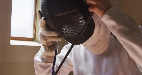 Fencer athlete during a fencing training in a gym