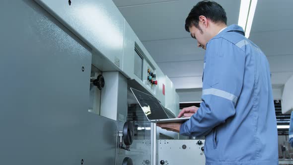 specialist worker engineer team control and operate printing package lable machine