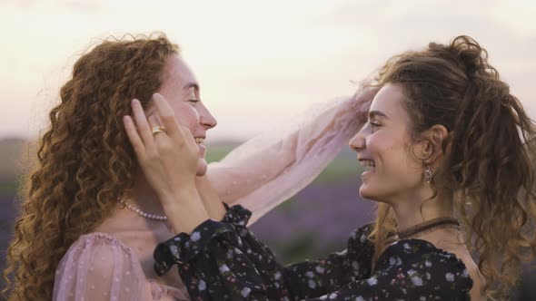 Two Beautiful Curly Girls Combing Together Their Hair Outdoors