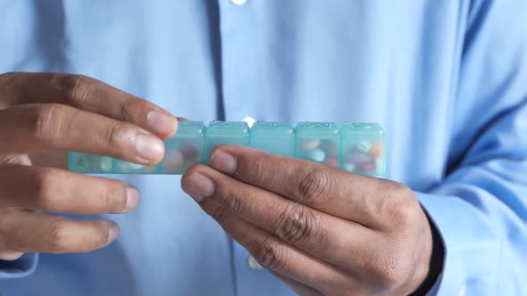 Close Up of Man Hand Taking Pills From Pill Box 
