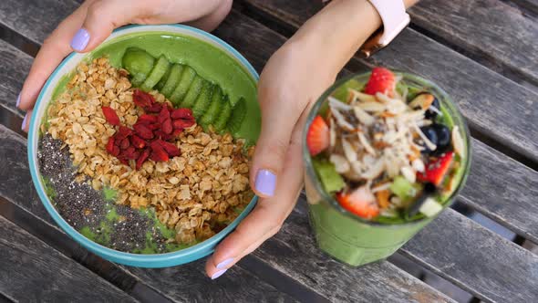 Woman Hands Holding Vegan Avocado Smoothie Bowl For Healthy Breakfast.