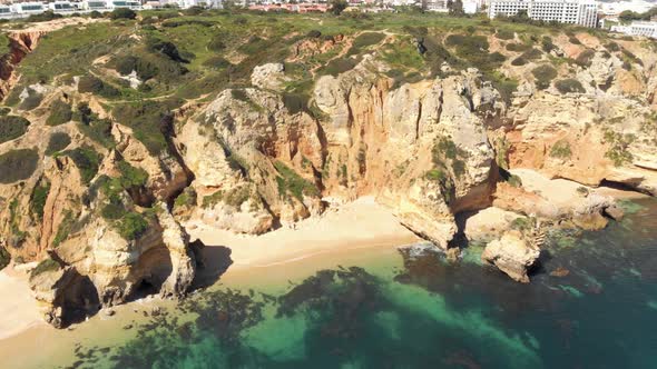 Small enclosed Camilo Beach in rugged Lagos Coastline, Algarve, Portugal