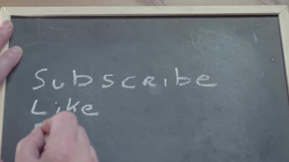 Subscribe like share written by hand on blackboard with chalk