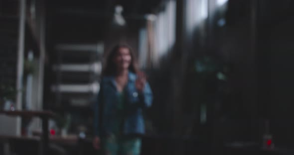 Young woman arriving at the reserved table for dinner