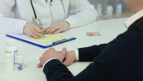 Healthcare Worker Making Diagnosis, Prescribing Patient Pills for Treatment