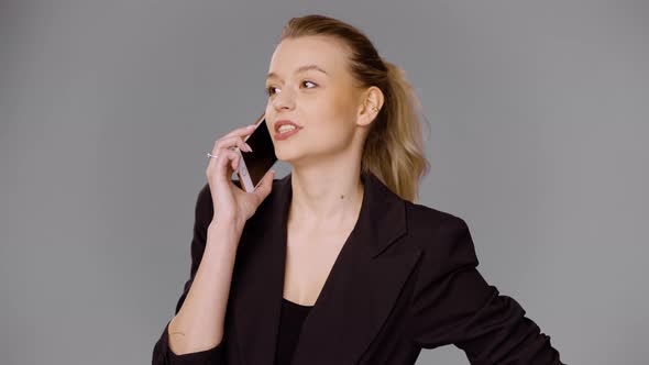 Female Entrepreneur Talking on Smartphone in Studio