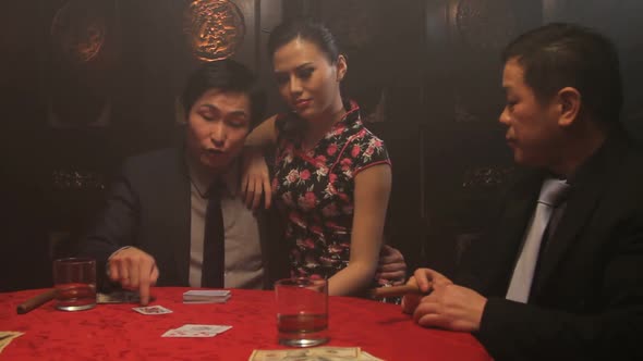 Businessmen playing cards in Casino