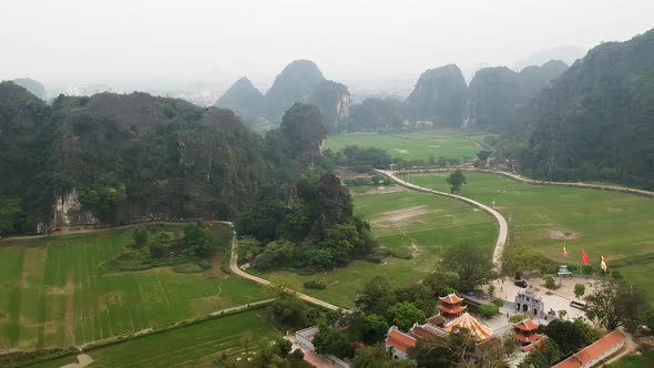 Aerial view of Vietnamese countryside, Limestone rocks and Thai Vi Temple in Tam Coc, Ninh Binh, Vie