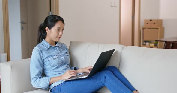 Woman Work on Computer and Sit on Sofa at Home