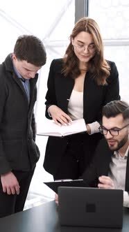 Three Coworkers Working on a Project at Office