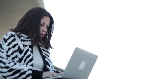 Slow Motion Shot of Concentrated Young Woman Typing on Laptop