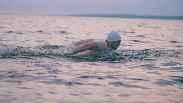 Athlete Is Crossing the Waters with Butterfly Stroke